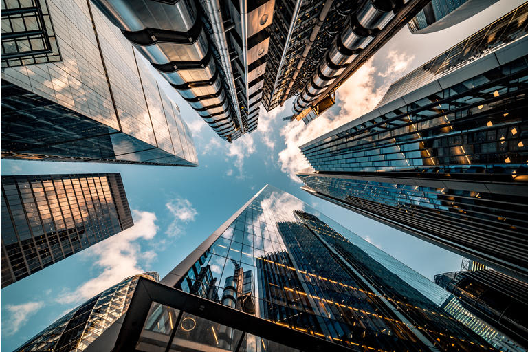 Looking directly up at the skyline of the financial district in central London - stock image