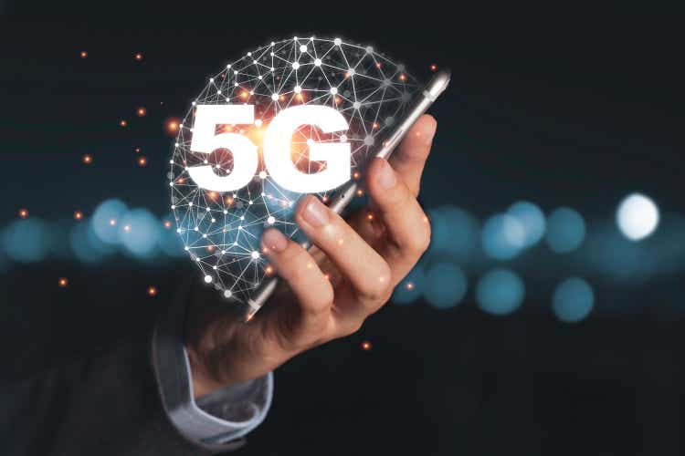 Businessman holding mobile phone with 5G infographic. 5 Generation wireless technology of mobile signal which big change for internet of thing.