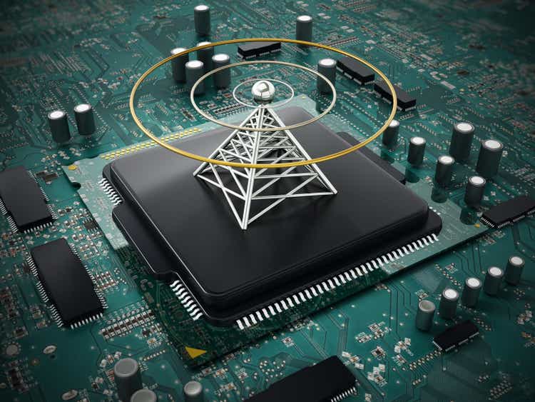 Antenna tower standing on black microprocessor of a circuit board