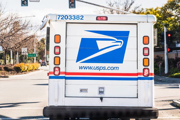 USPS vehicle delivering mail and packages