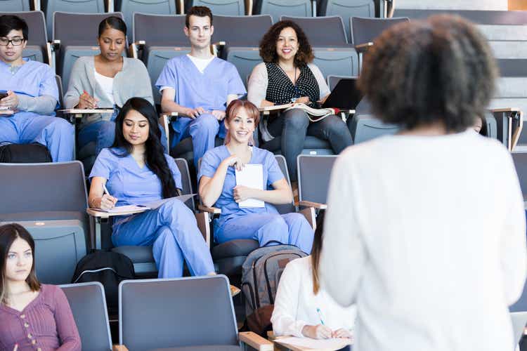 Professor teaches a class of medical students