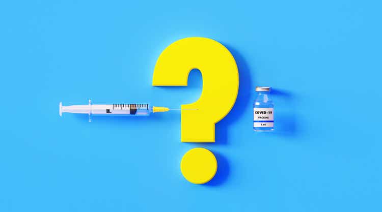 COVID-19 Vaccine Bottle Question Mark and Syringe on Blue Background