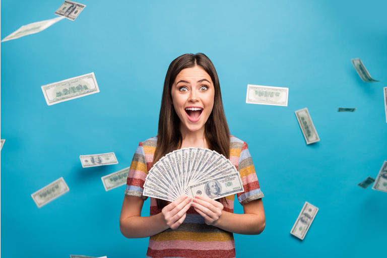 Close-up portrait of her she nice lovely pretty amazed crazy overjoyed cheerful cheery girl holding in hand fan cashback sale discount isolated over bright vivid shine vibrant blue color background