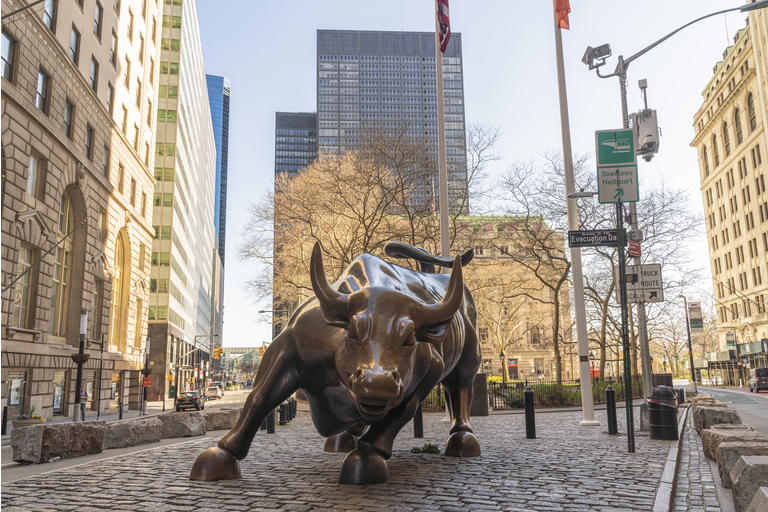 The iconic Charging Bull statue is not surrounded by the usual crowd because the city is deserted during the state of emergency triggered by the COVID-19 pandemic.