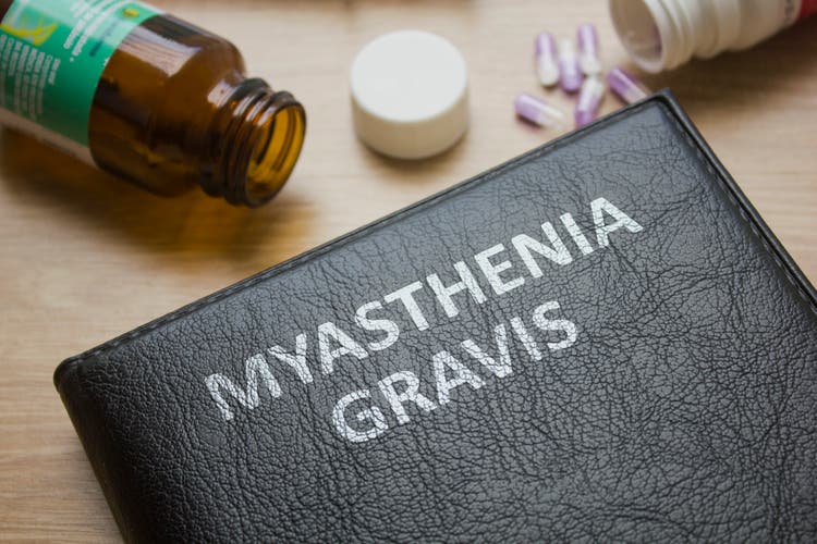 Book about Myasthenia gravis and medication, injection, syringe and pills