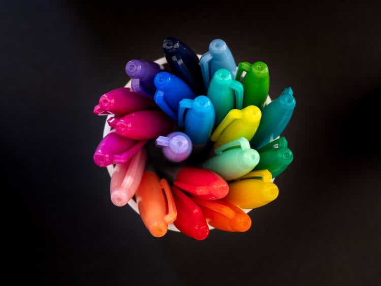 Top down view of colouring pens spiralling in a pot