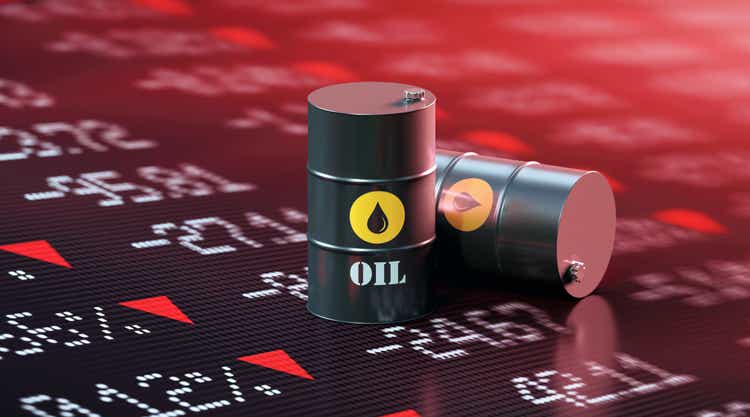 Oil Drums Sitting Over A Trading Board Which is Showing A Stock Market Crash