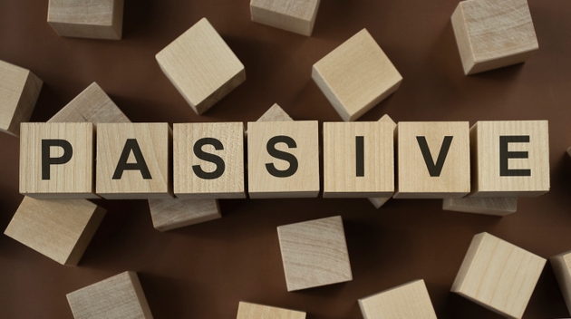 PASSIVE Word Written In Wooden Cube on a brown background