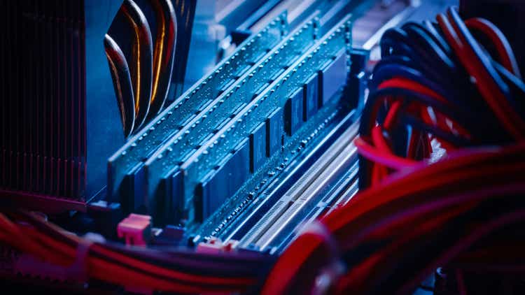 Close-up Macro Shot of Installed RAM Memory in Computer Motherboard Slot. Technically Advanced PC / Server System. Modern High-End PC Shot in Stylish Neon, Pink-Blue Colors.