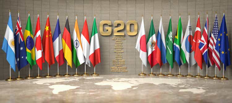 G20 summit or meeting concept. Row from flags of members of G20 Group of Twenty and list of countries in a conference room.