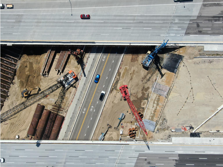 Aerial view of highway bridge construction over small river