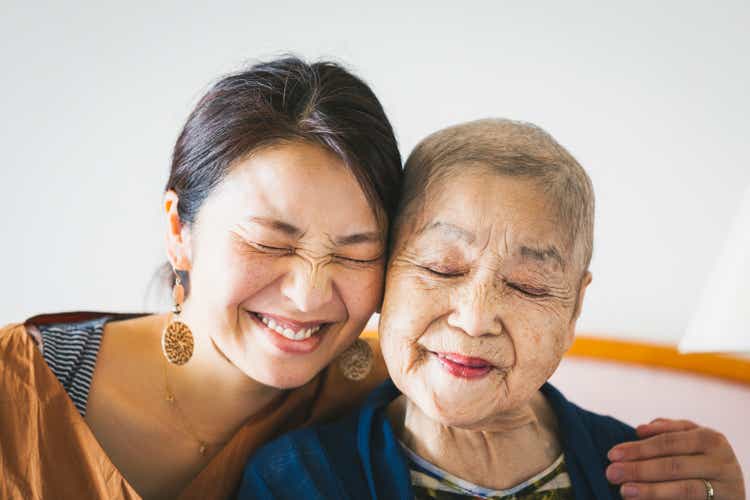 Portrait of old mother with cancer and her middle aged daughter