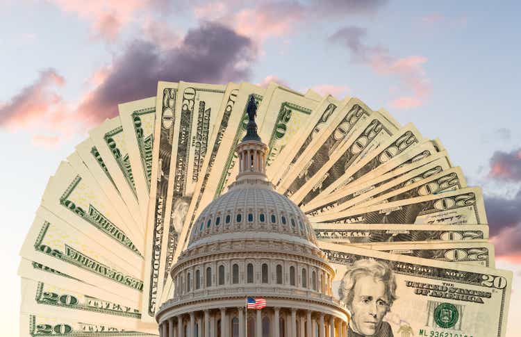 Flag flies in front of Capitol in DC with cash behind the dome as concept for stimulus virus payment