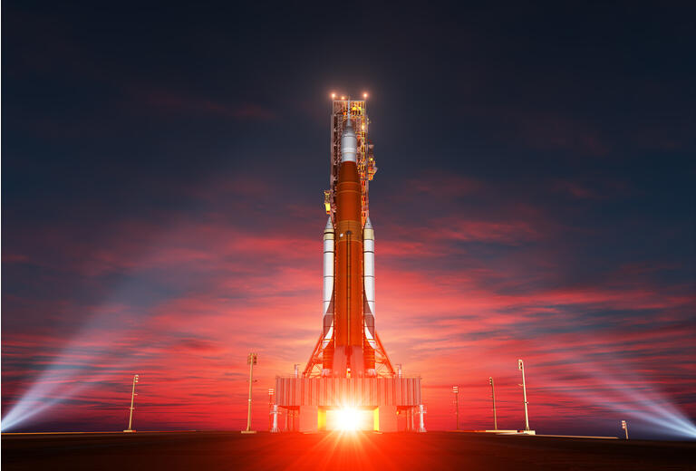 Space Launch System On Launchpad Over Background Of Sunrise