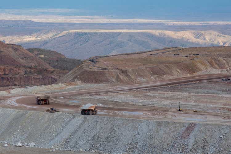 Dump trucks haul earth from strip mine operation in remote area