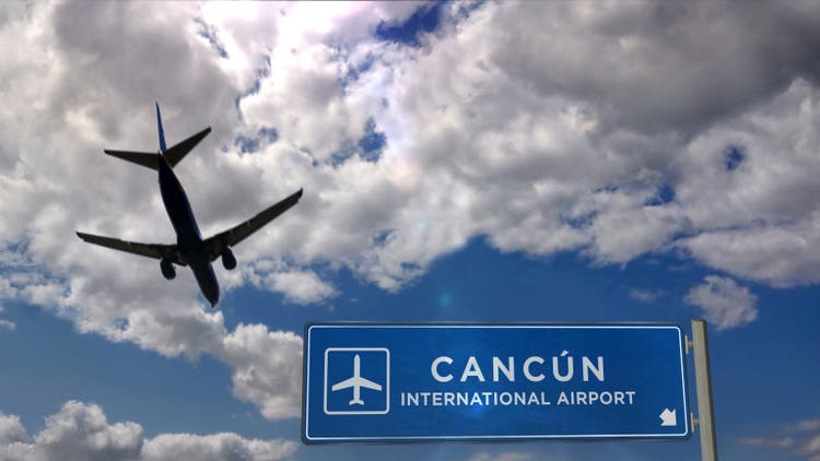 Plane landing in Cancún Mexico with signboard