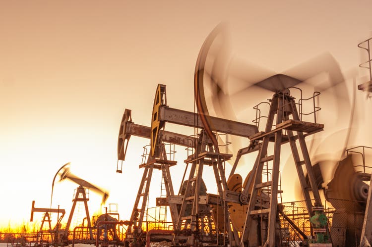 Oil pump rig. Oil and gas production. Oilfield site. Pump Jack are running. Drilling derricks for fossil fuels output and crude oil production. War on oil prices. Global coronavirus COVID 19 crisis.