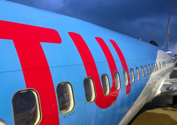 TUI logo on the side of a Boeing 737 holiday at Bristol airport floodlit in early morning.
