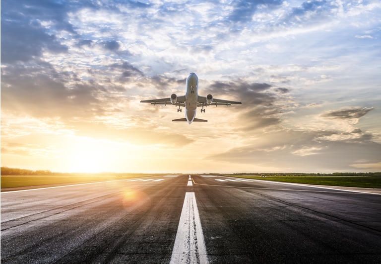 Passenger airplane taking of at sunrise