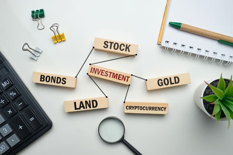 The concept of investing in stocks, gold, land, cryptocurrency.