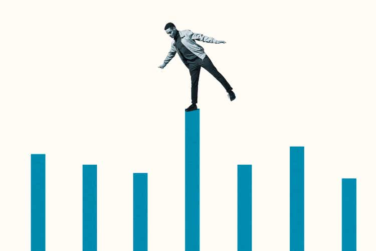 Confident young man on top of blue bar graph