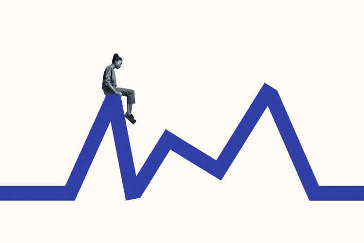 Side view of young woman sitting blue line graph