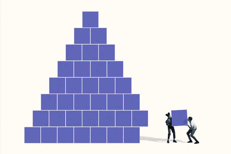 Man and woman building pyramid with blue blocks