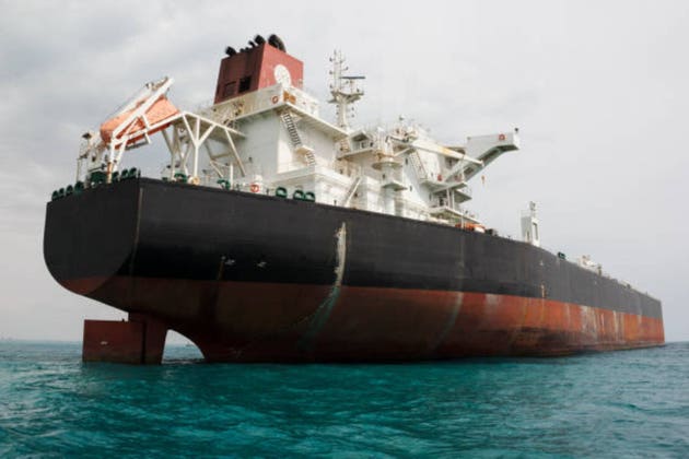 An oil tanker anchored near a petroleum terminal and offshore platform in Persian Gulf