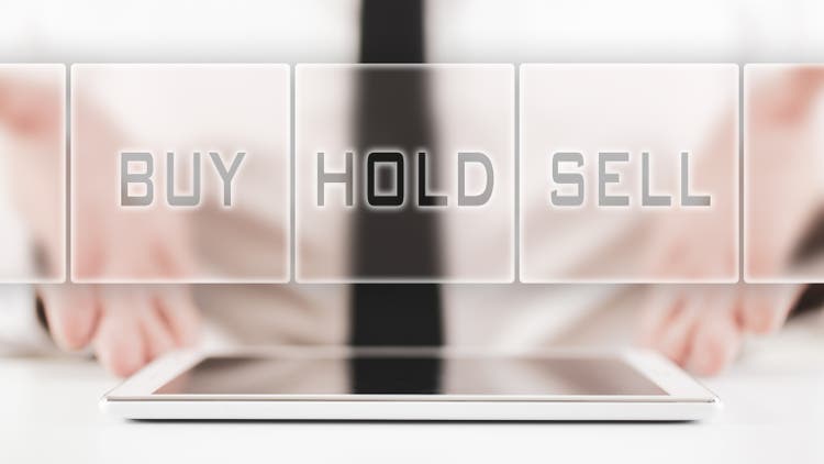Businessman offering a choice for stock traders of buy, hold or sell in a conceptual image
