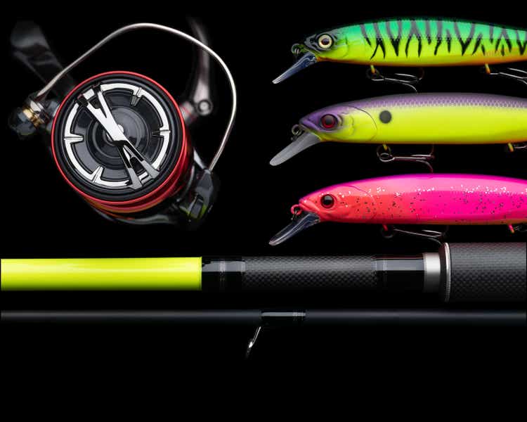 Fishing tackle background, closeup. Equipment for angling against dark background