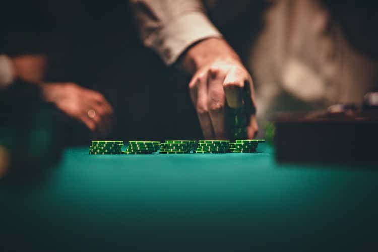 Gentlemen holding gambling chips in casino