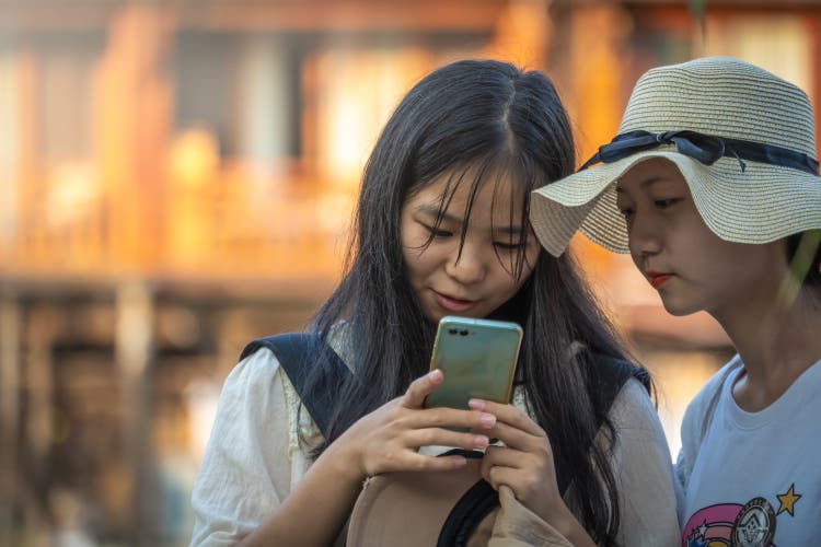 Chinese ladies looking at the mobile phone screen
