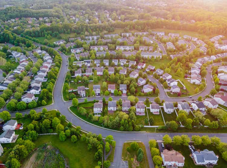 Aerial top view from a drone flying over residential area buildings and transportation