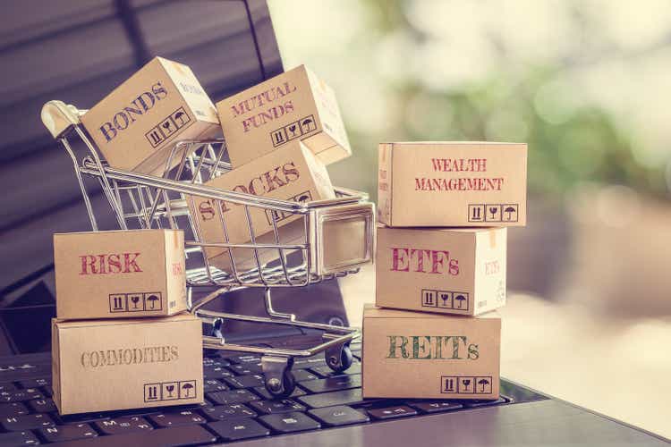 Boxes of financial products e.g bonds, commodities, stocks, mutual fund, ETFs, REITs on a laptop