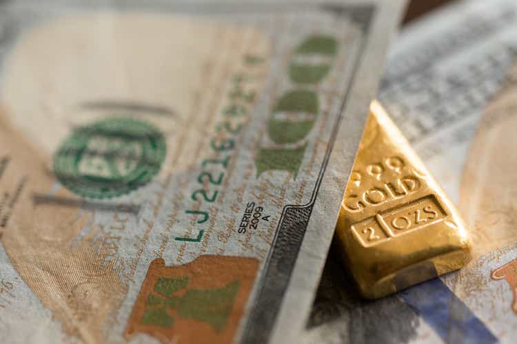 Gold bullion among US 100 Dollar