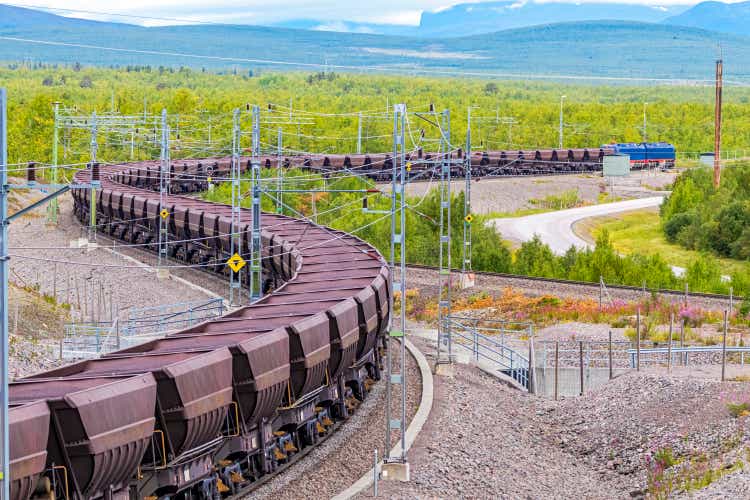 Loaded iron ore train in Arctic Circle extreme terrain hauled by electric locomotives