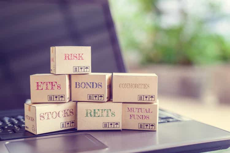 Boxes of financial products e.g risk, ETFs, bonds, commodity, stocks, REITs, mutual funds on a laptop