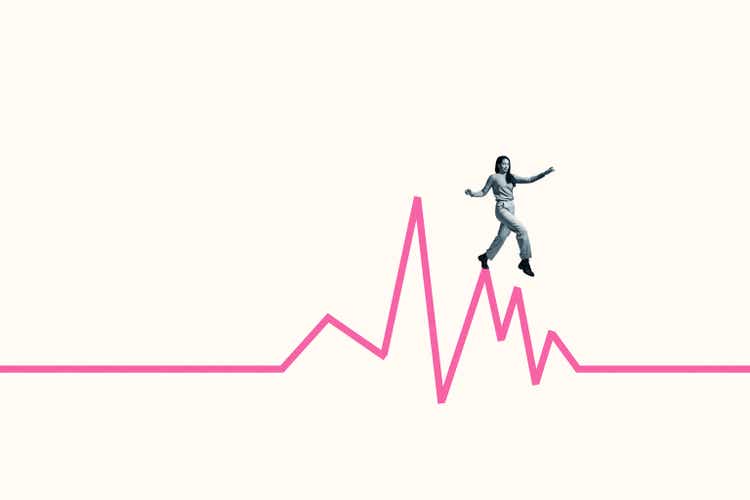 Woman balancing while walking on pink line graph