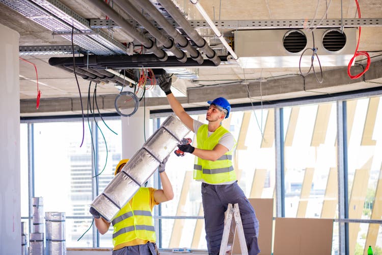 Man setting up ventilation system indoors