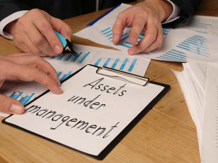 Assets under management is shown on the conceptual business photo