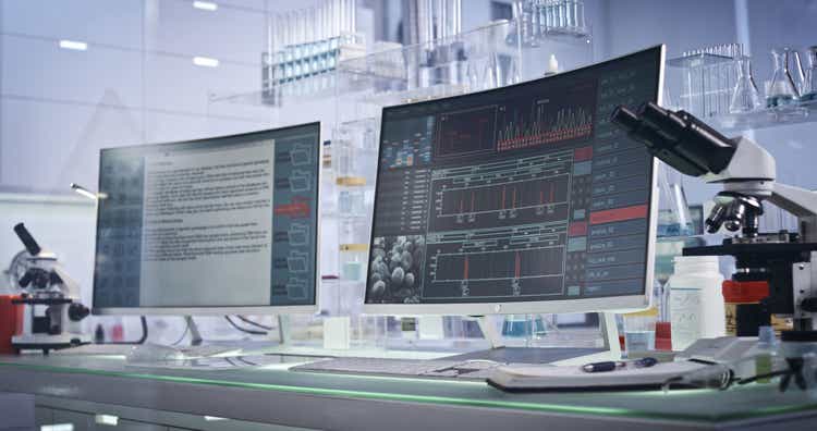 Futuristic laboratory equipment. DNA research on computer screens