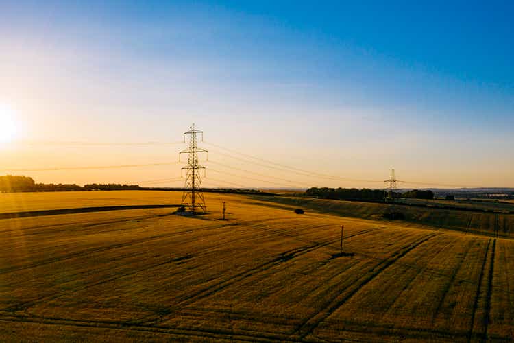 Electricity pylons in the countryside at sunset