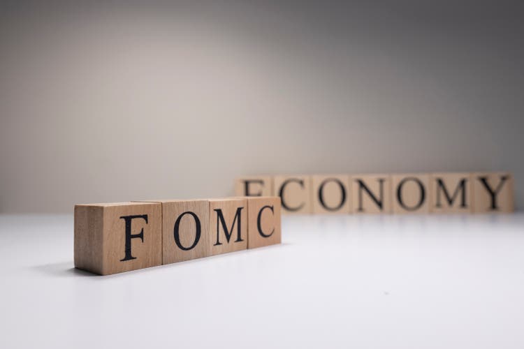 FOMC Meeting Minutes Word via Candlestick Forex Wallpaper. Close up.