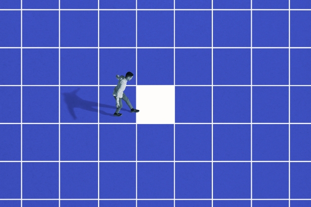 Side view of young man walking on blue grid