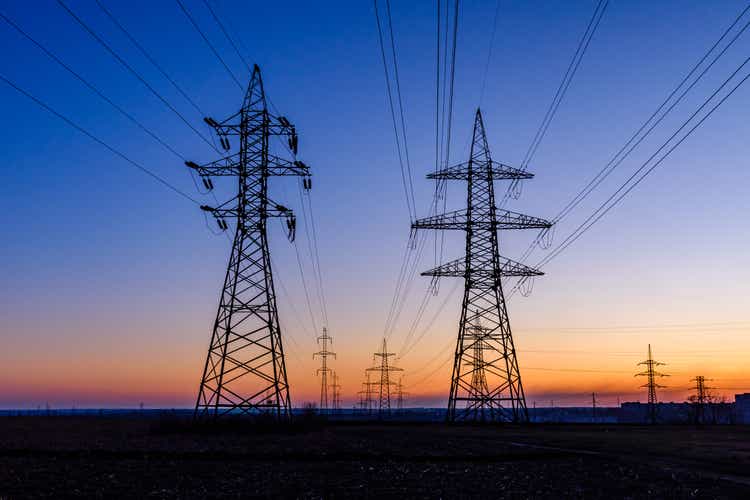 High voltage power line in a field at sunset