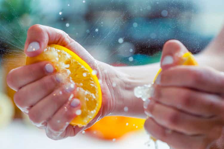 Woman squeezing the juice from a lemon.