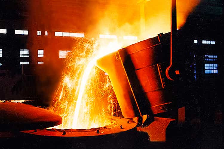 a large bowl of molten metal in a steel mill.  Steel production.