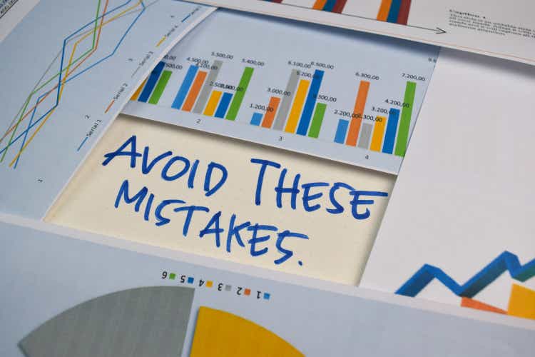 Avoid These Mistakes write on a book isolated on Office Desk. Stock market concept