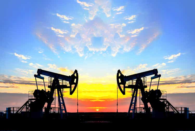 Oil drilling derricks at desert oilfield for fossil fuels output and crude oil production from the ground. Oil drill rig and pump jack