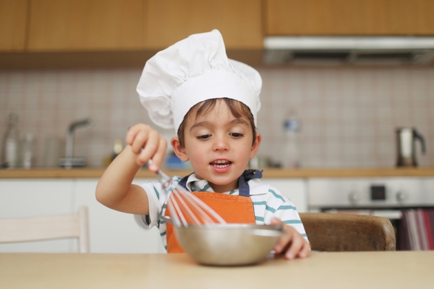 A 4 year old boy disguised as a cook